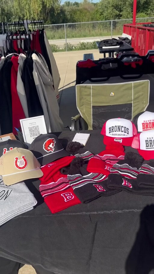 Mockingbird Markets pop-up table with apparel and hats